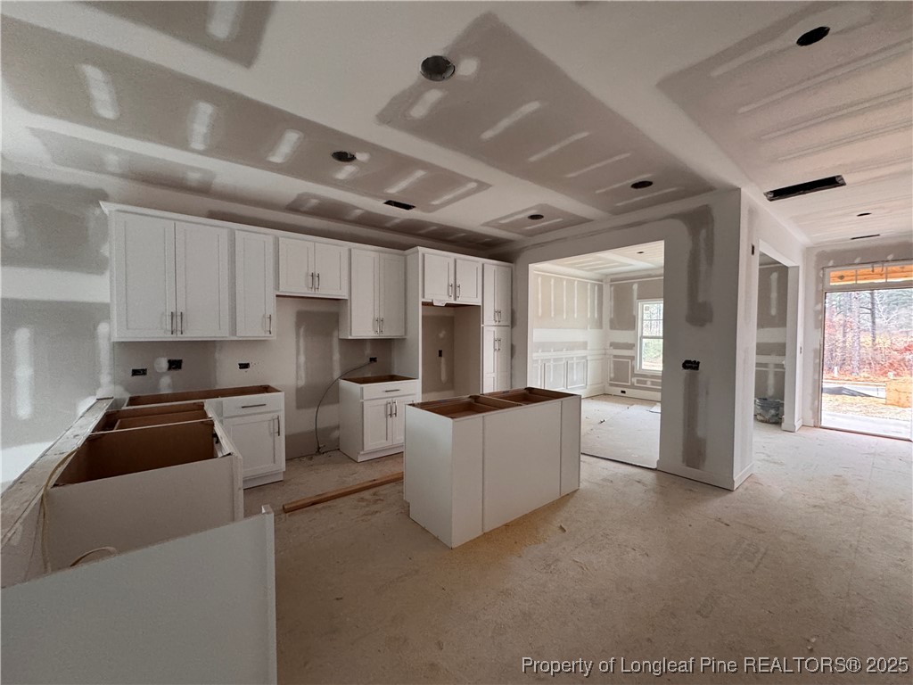 653 Watauga Lane Aberdeen, NC 28315 - Photo 15 of 38 a living room with furniture a flat screen tv and a refrigerator