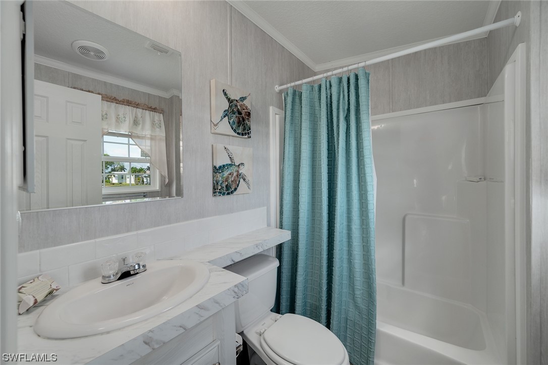 132 Cape Sable Drive Naples, FL 34104 - Photo 14 of 20 a bathroom with a sink toilet and shower