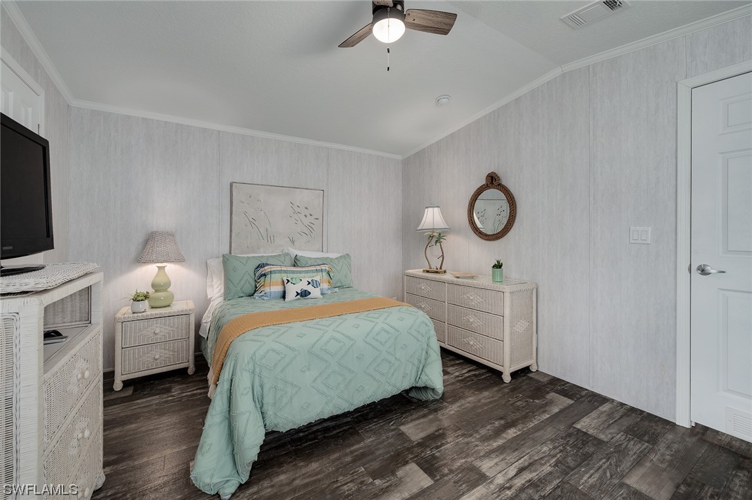 132 Cape Sable Drive Naples, FL 34104 - Photo 16 of 20 a bedroom with a bed and a chandelier