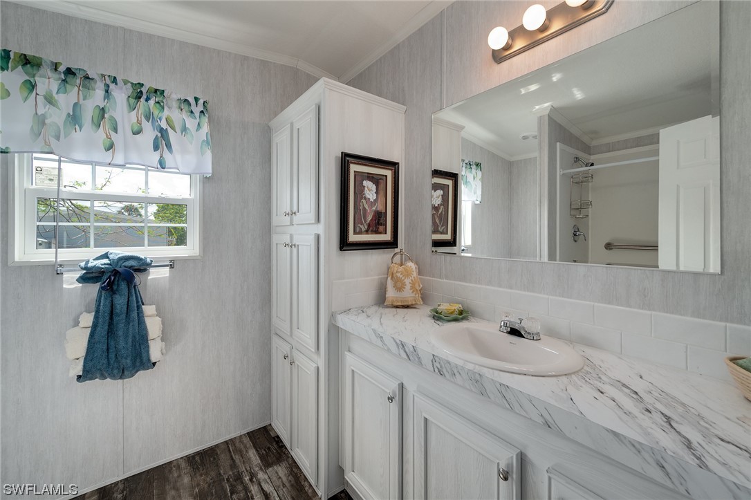 132 Cape Sable Drive Naples, FL 34104 - Photo 17 of 20 a bathroom with a sink and a mirror