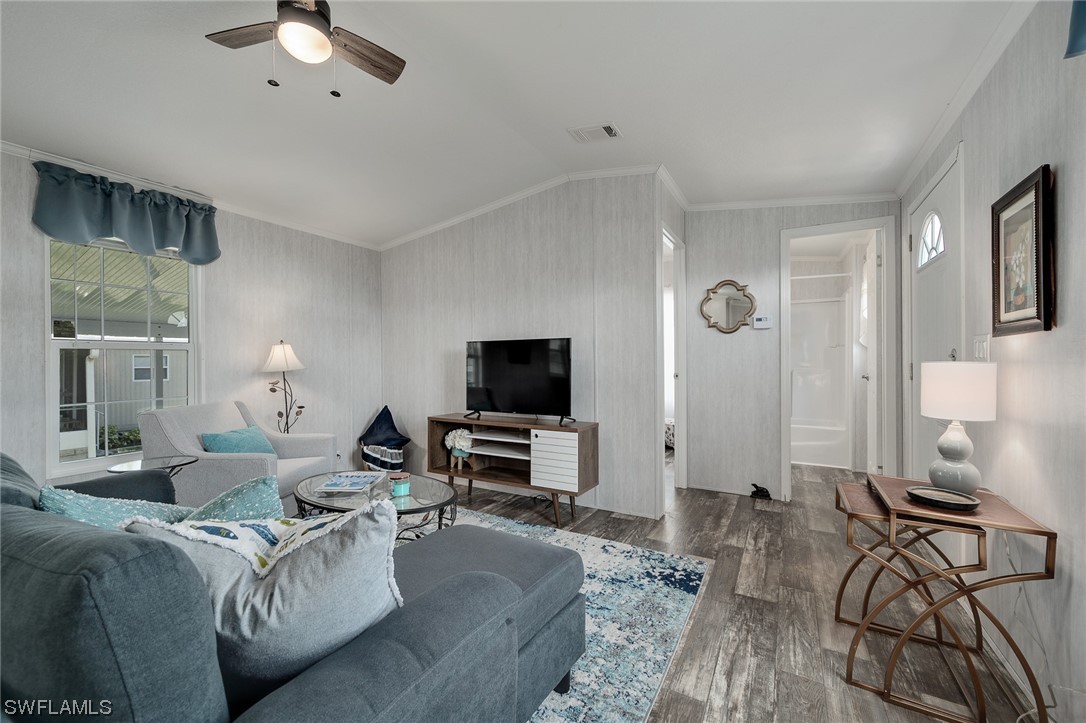 132 Cape Sable Drive Naples, FL 34104 - Photo 7 of 20 a living room with furniture and a flat screen tv