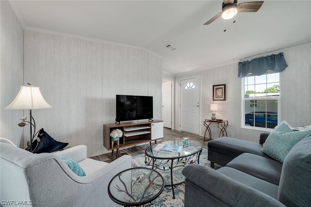 132 Cape Sable Drive Naples, FL 34104 - Photo 8 of 20 a living room with furniture a window and a flat screen tv