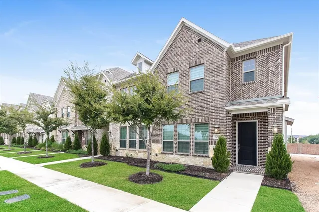a front view of a house with a yard and fountain