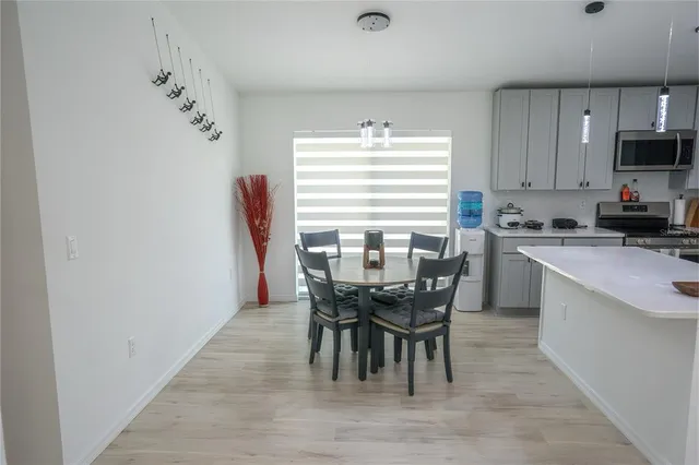 a view of a dining room with furniture and wooden floor