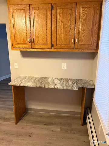 a kitchen with granite countertop a stove sink and cabinets