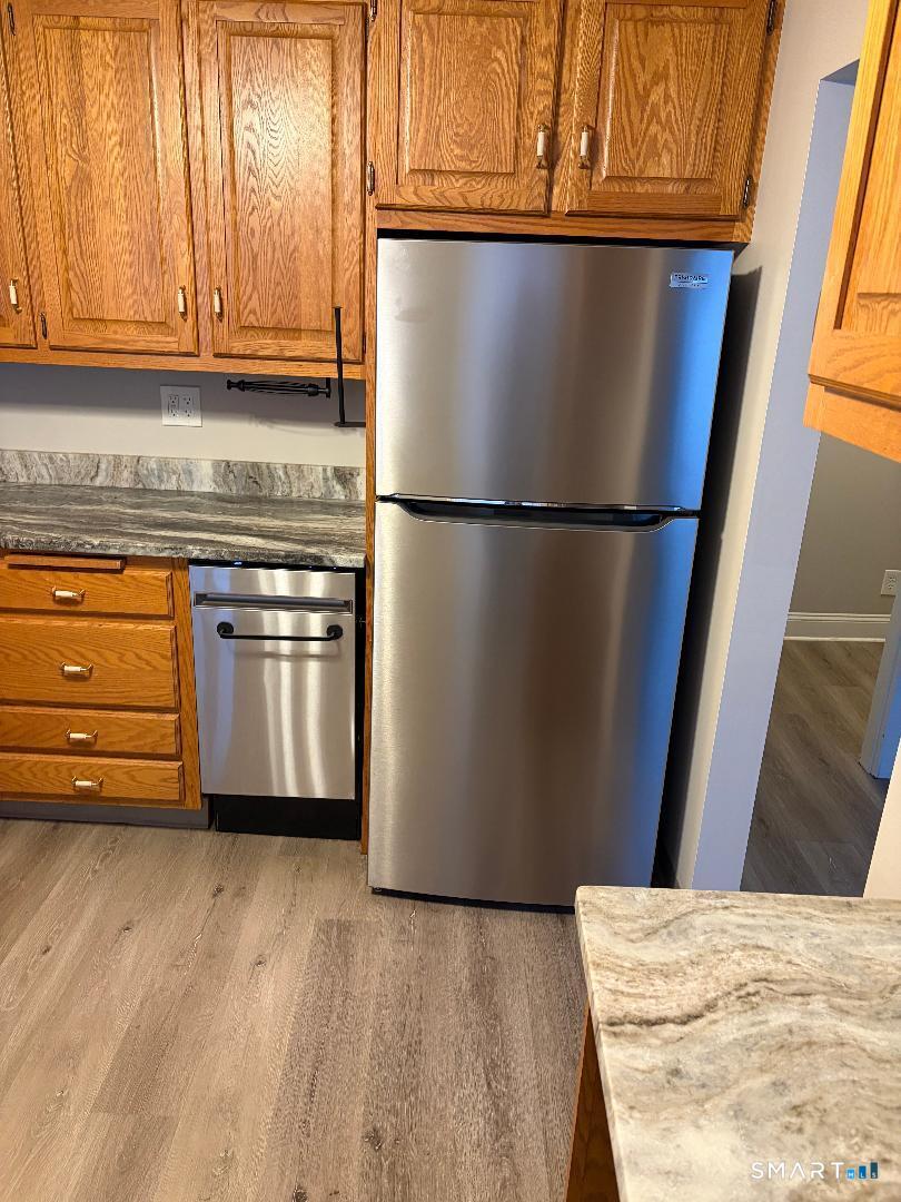 65 Ingraham Street, Unit 2 Bristol, CT 06010 - Photo 5 of 11 a white refrigerator freezer sitting in a kitchen