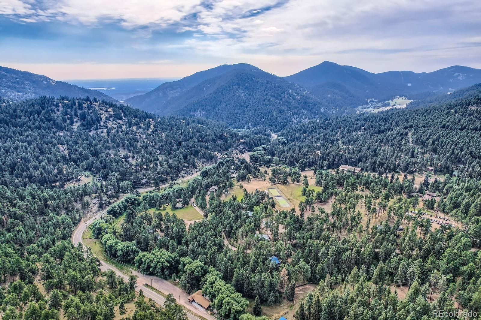 5296 Cherokee Road Indian Hills, CO 80454 - Photo 11 of 26 a view of a house with a mountain in the background