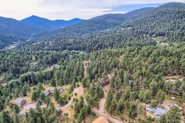 a view of a mountain in the distance in a field