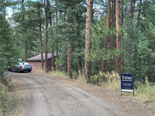 a view of a chairs and table in a backyard