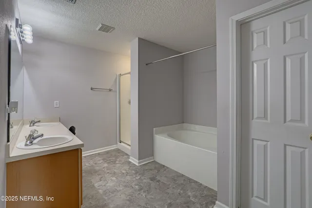 a bathroom with a tub a sink and a mirror