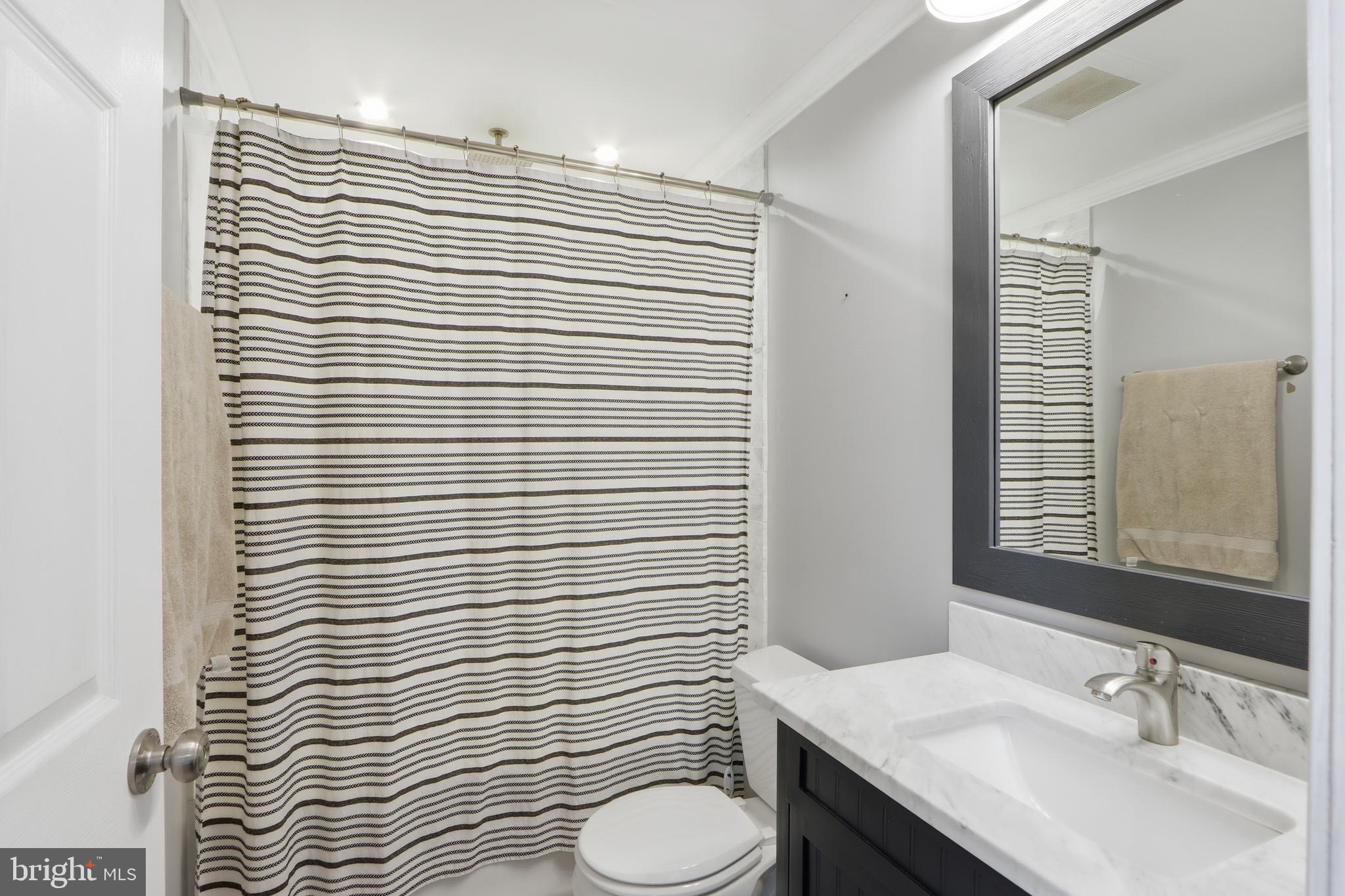 2014 Putnam Road Halethorpe, MD 21227 - Photo 14 of 30 a bathroom with a granite countertop sink toilet and mirror