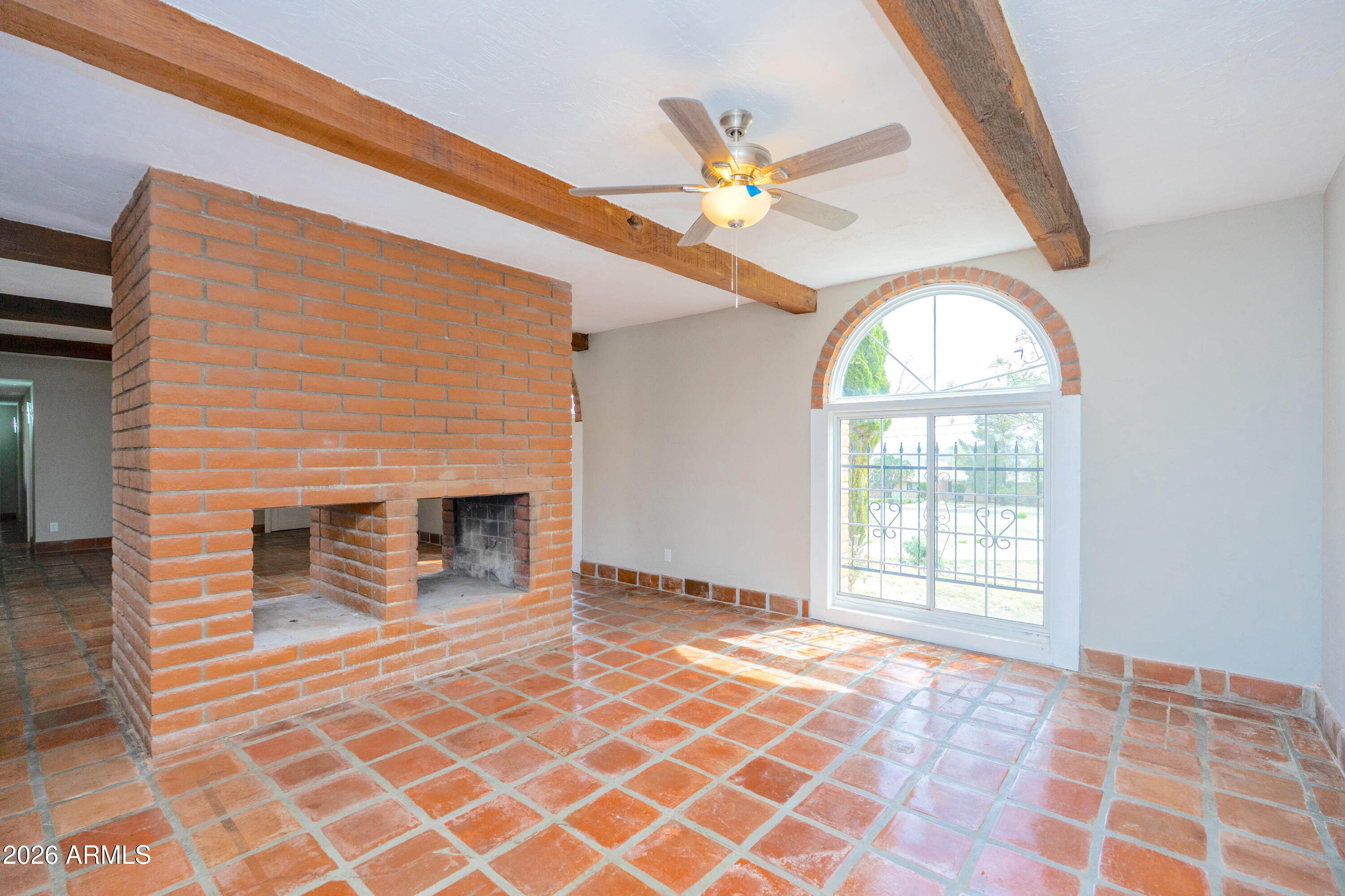 4 Cochise Lane Bisbee, AZ 85603 - Photo 11 of 72 a view of an empty room with a fireplace and a window