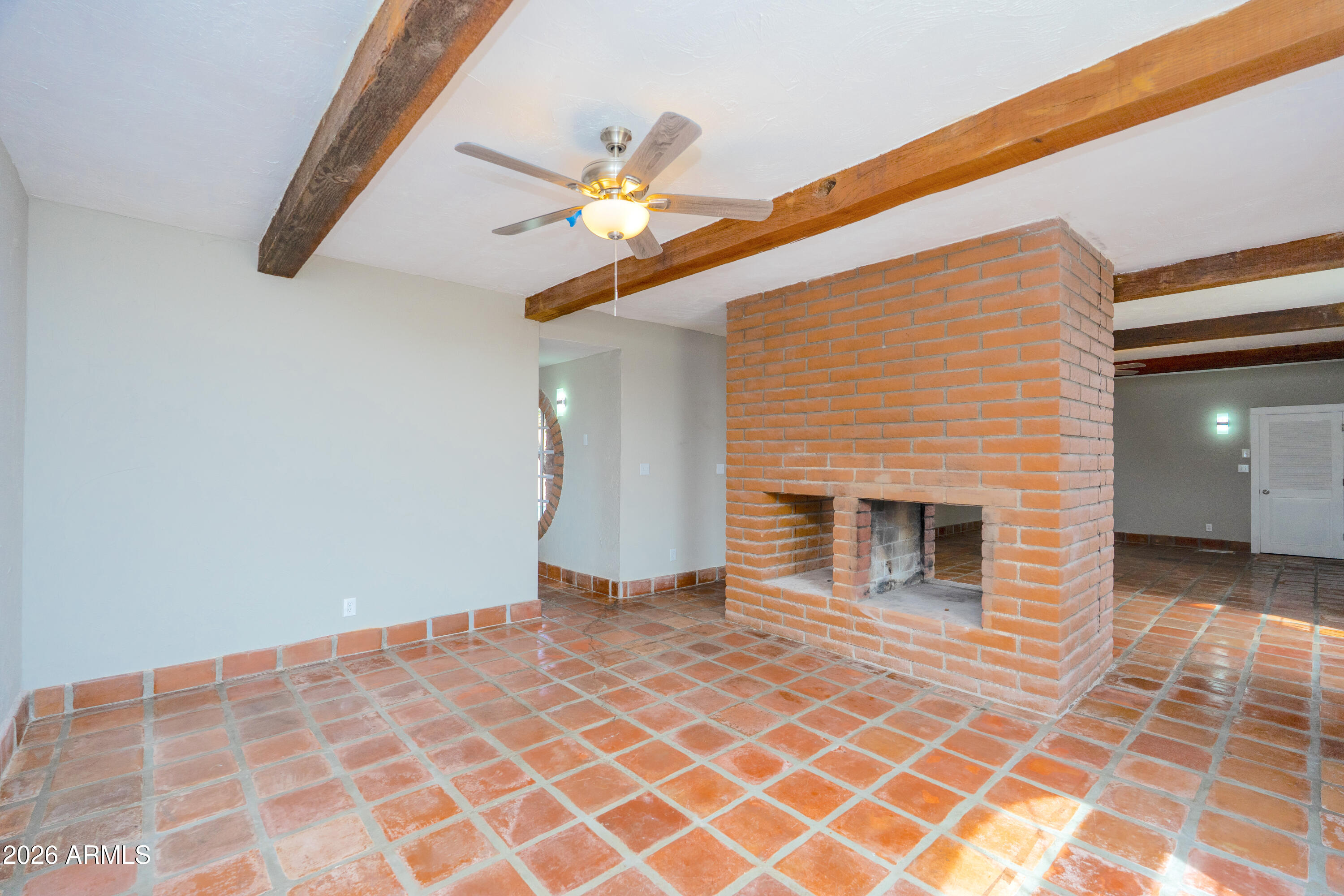 4 Cochise Lane Bisbee, AZ 85603 - Photo 12 of 72 a view of an empty room with wooden floor and a ceiling fan