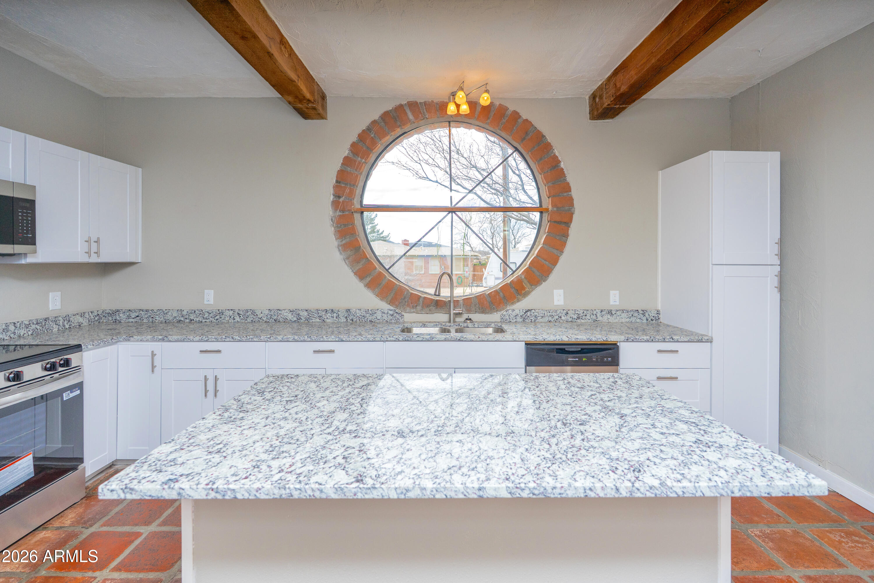 4 Cochise Lane Bisbee, AZ 85603 - Photo 15 of 72 a kitchen with a stove a sink and a wooden cabinets