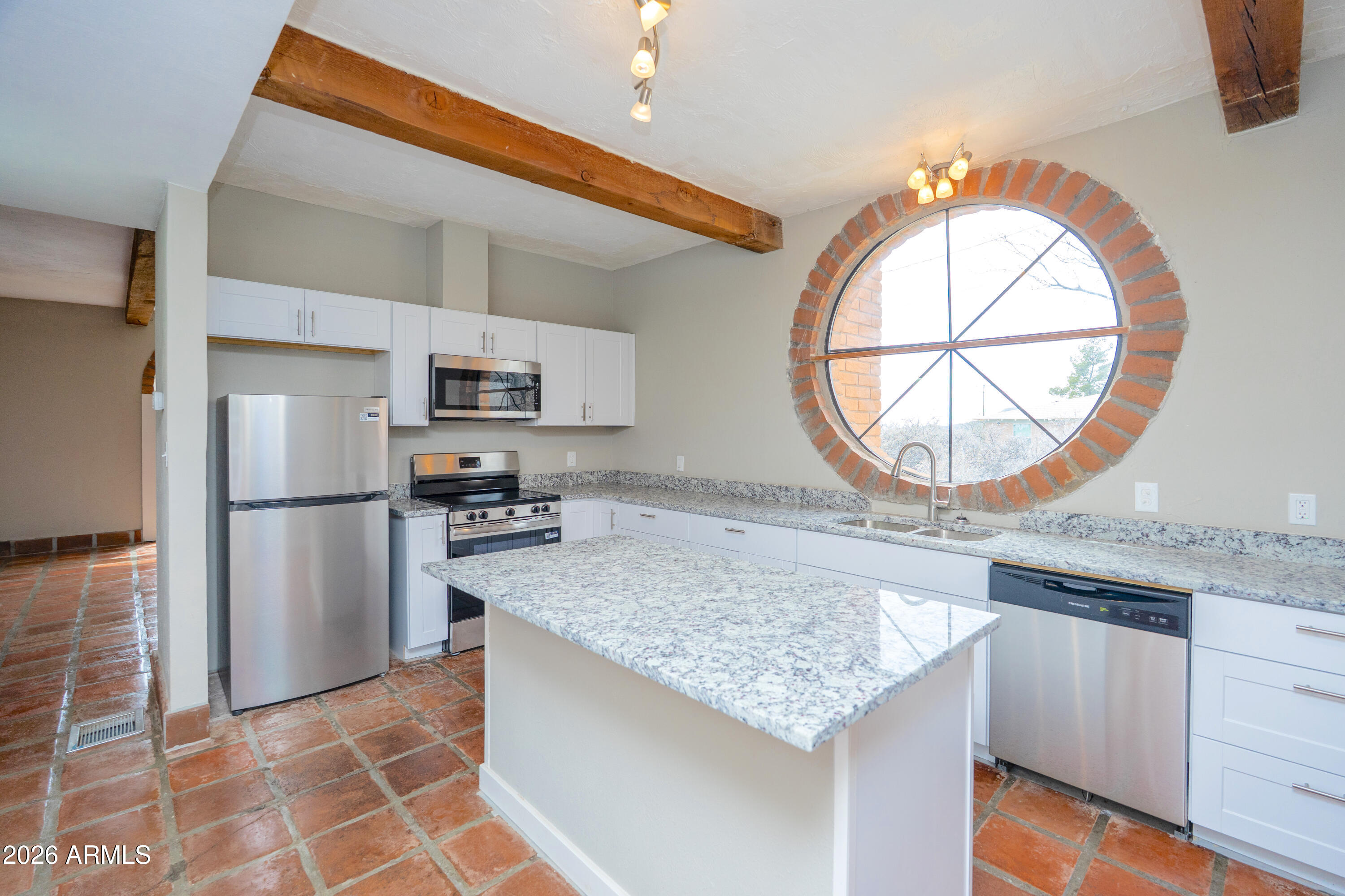 4 Cochise Lane Bisbee, AZ 85603 - Photo 16 of 72 a kitchen with granite countertop a stove a refrigerator and a microwave