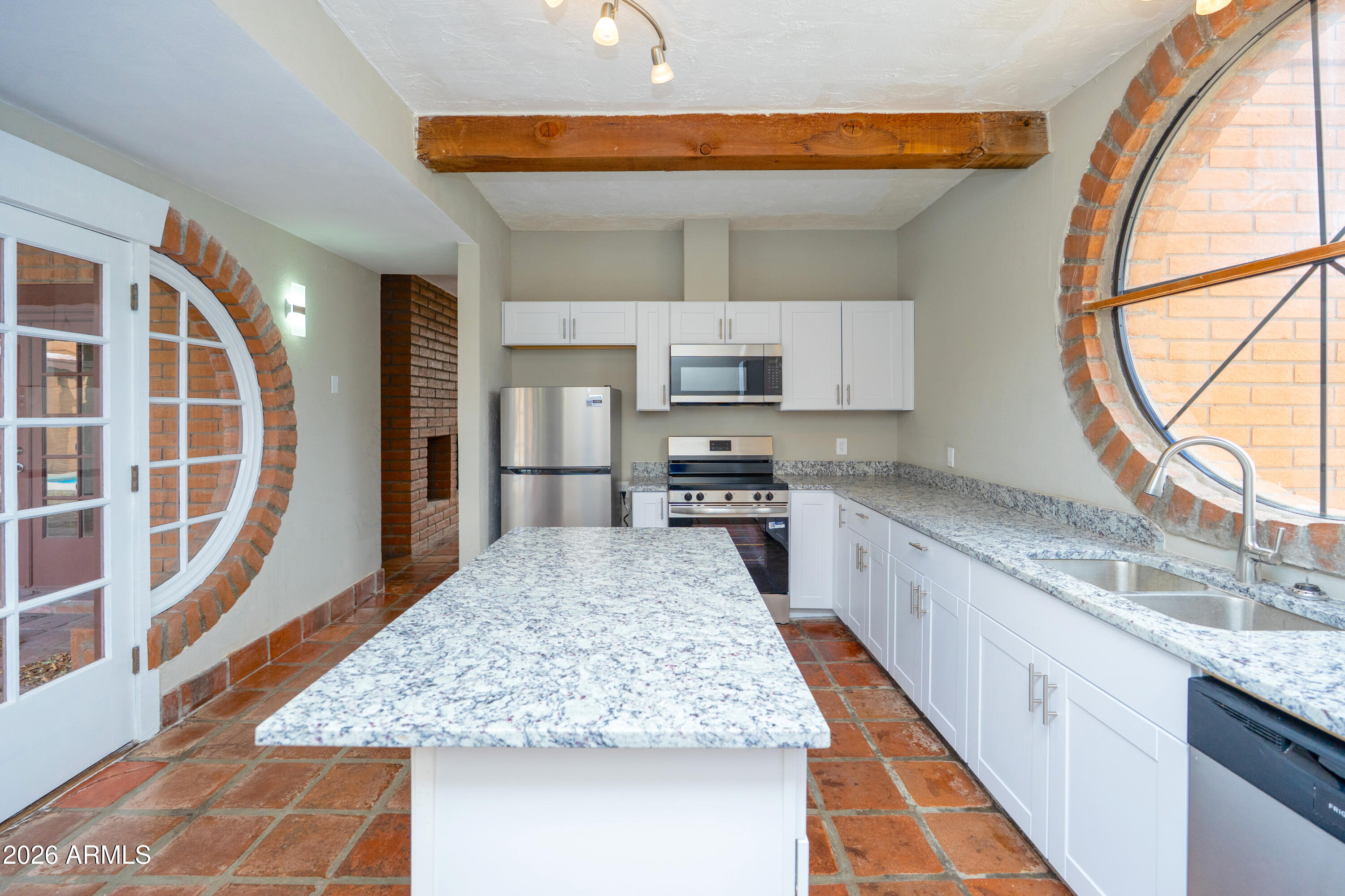 4 Cochise Lane Bisbee, AZ 85603 - Photo 17 of 72 a large kitchen with kitchen island granite countertop wooden cabinets a granite counter top and a stainless steel appliances