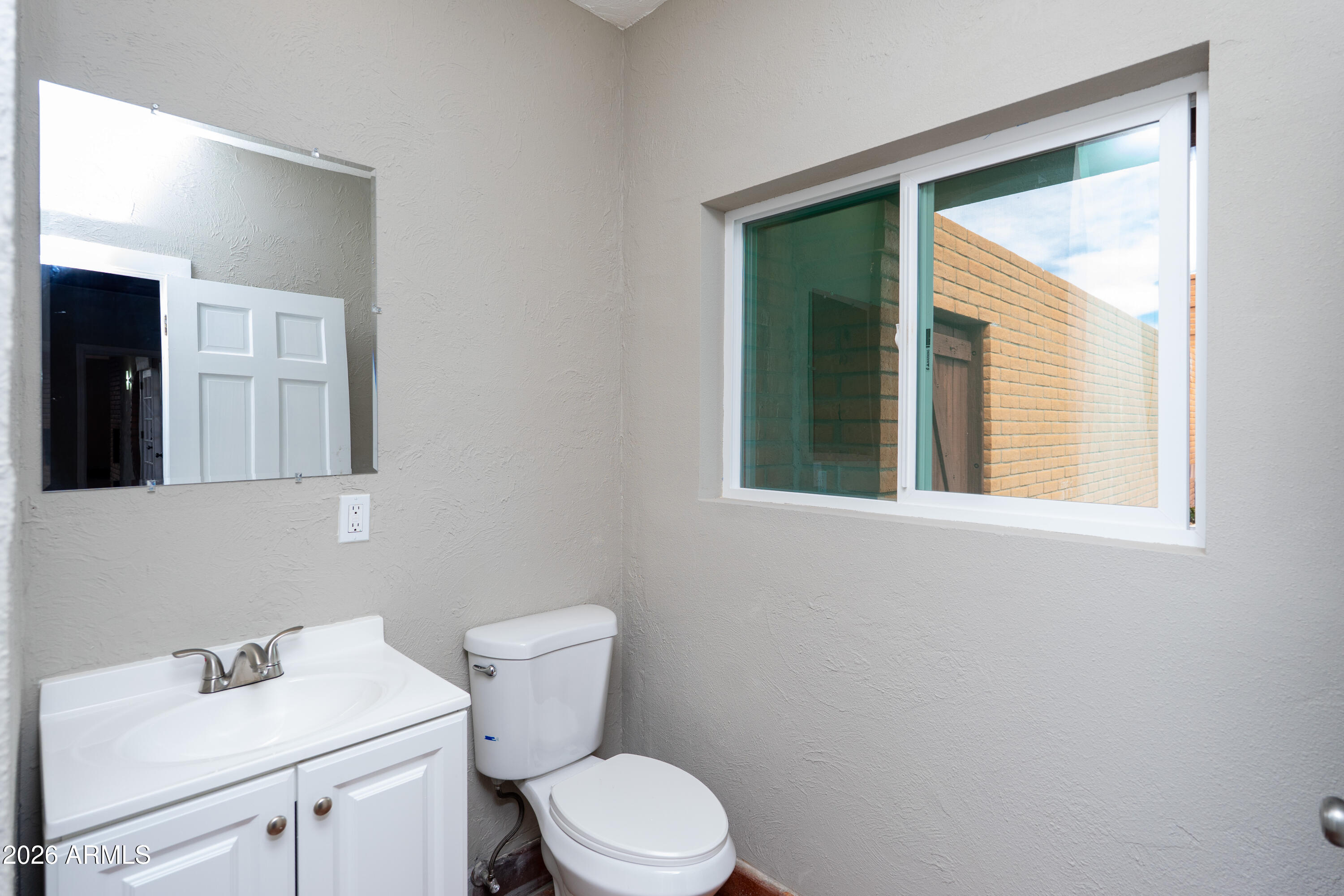 4 Cochise Lane Bisbee, AZ 85603 - Photo 24 of 72 a bathroom with a toilet sink vanity and mirror