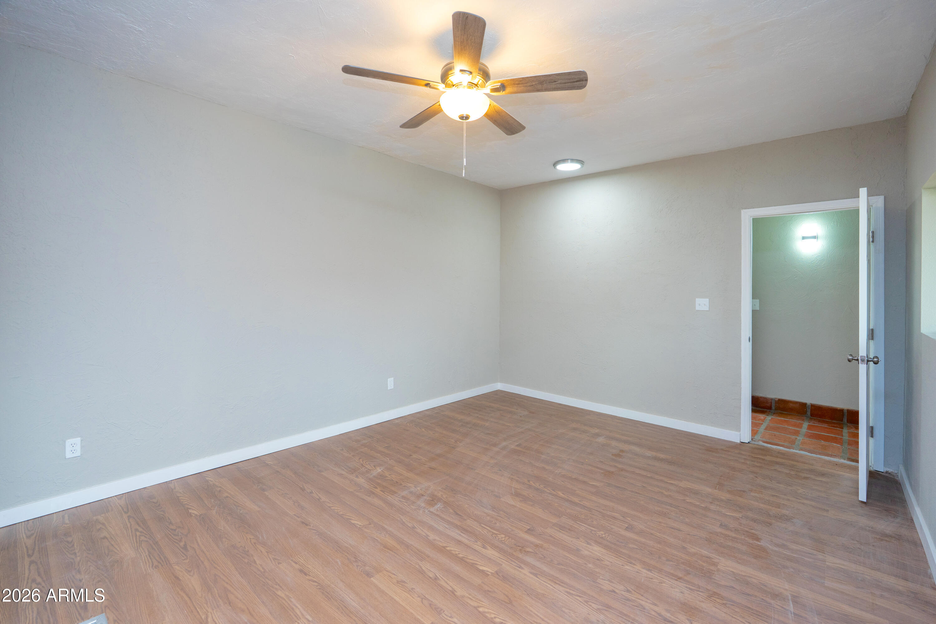 4 Cochise Lane Bisbee, AZ 85603 - Photo 36 of 72 wooden floor in an empty room with a fan