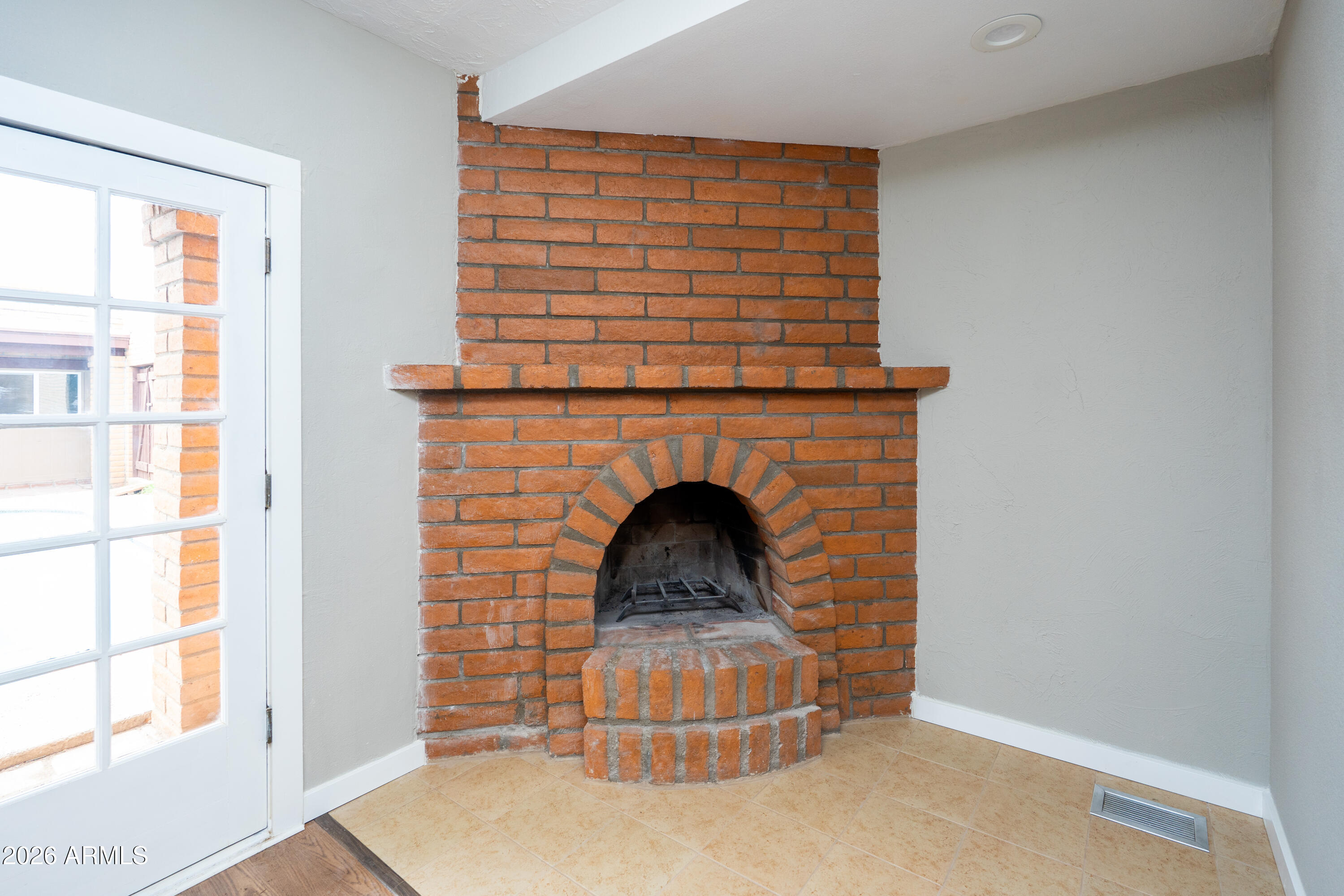 4 Cochise Lane Bisbee, AZ 85603 - Photo 39 of 72 a living room with a fireplace and a window