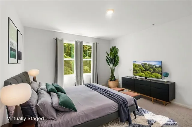 a bedroom with bed and a couch