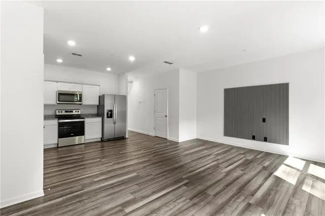 a view of kitchen with sink stainless steel appliances and cabinets