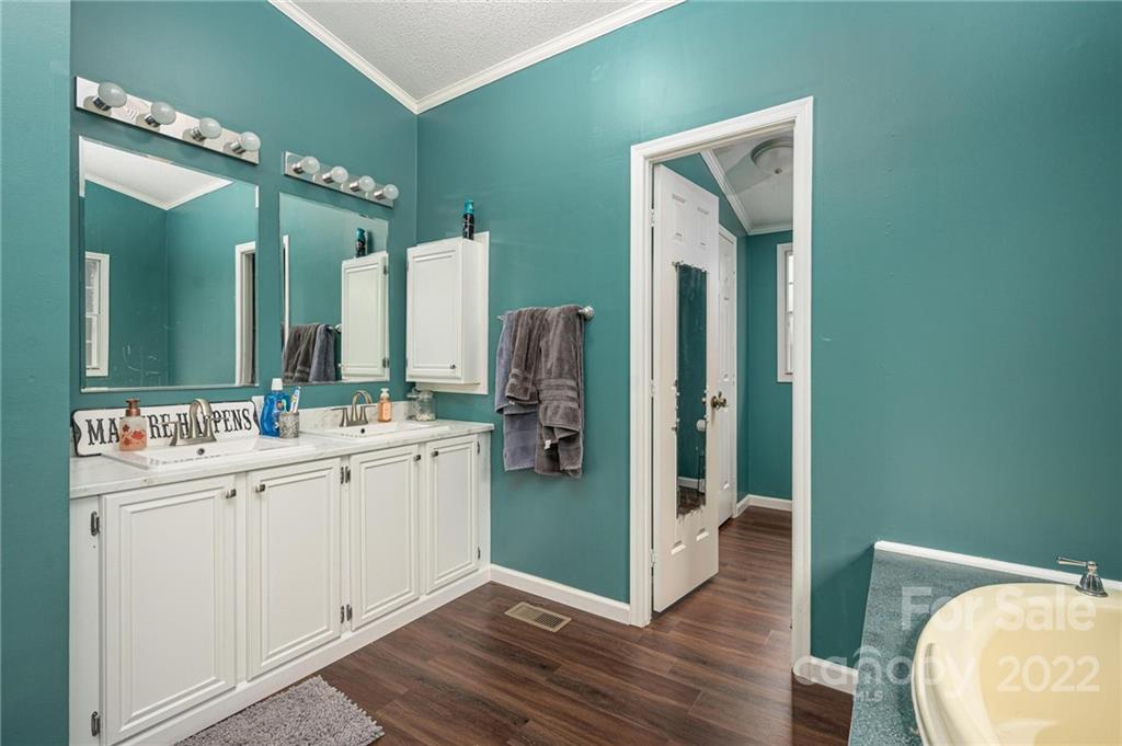 2776 Devine Road Iron Station, NC 28080 - Photo 13 of 23 a bathroom with a double vanity sink and mirror