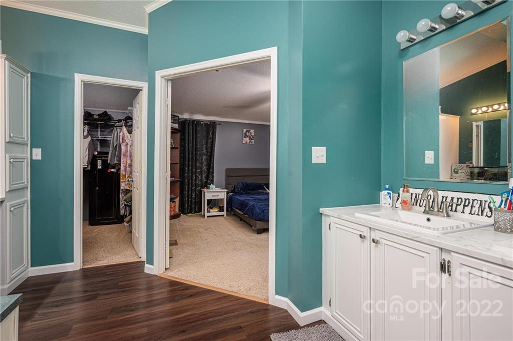 2776 Devine Road Iron Station, NC 28080 - Photo 14 of 23 a en suite bathroom with a sink mirror and vanity