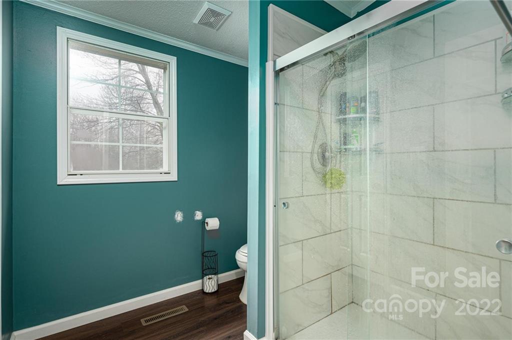 2776 Devine Road Iron Station, NC 28080 - Photo 15 of 23 a bathroom with a toilet and a shower