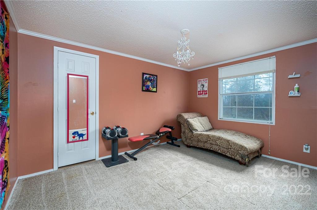 2776 Devine Road Iron Station, NC 28080 - Photo 16 of 23 a living room with furniture gym equipment and a window