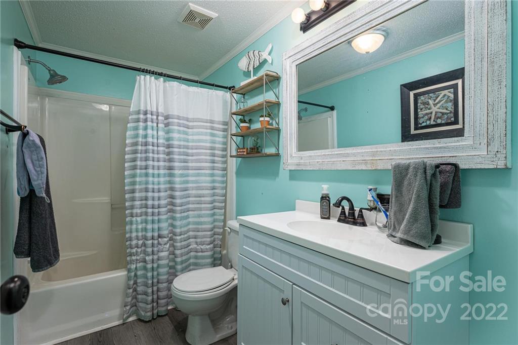 2776 Devine Road Iron Station, NC 28080 - Photo 18 of 23 a bathroom with a sink a toilet and shower