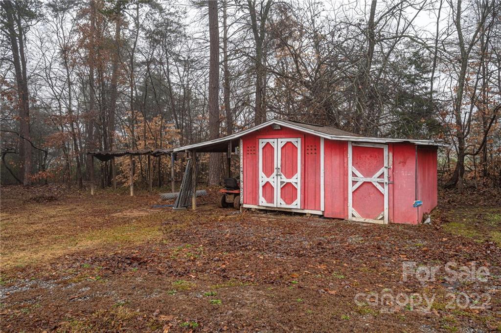 2776 Devine Road Iron Station, NC 28080 - Photo 23 of 23 a backyard with wooden fence and large trees