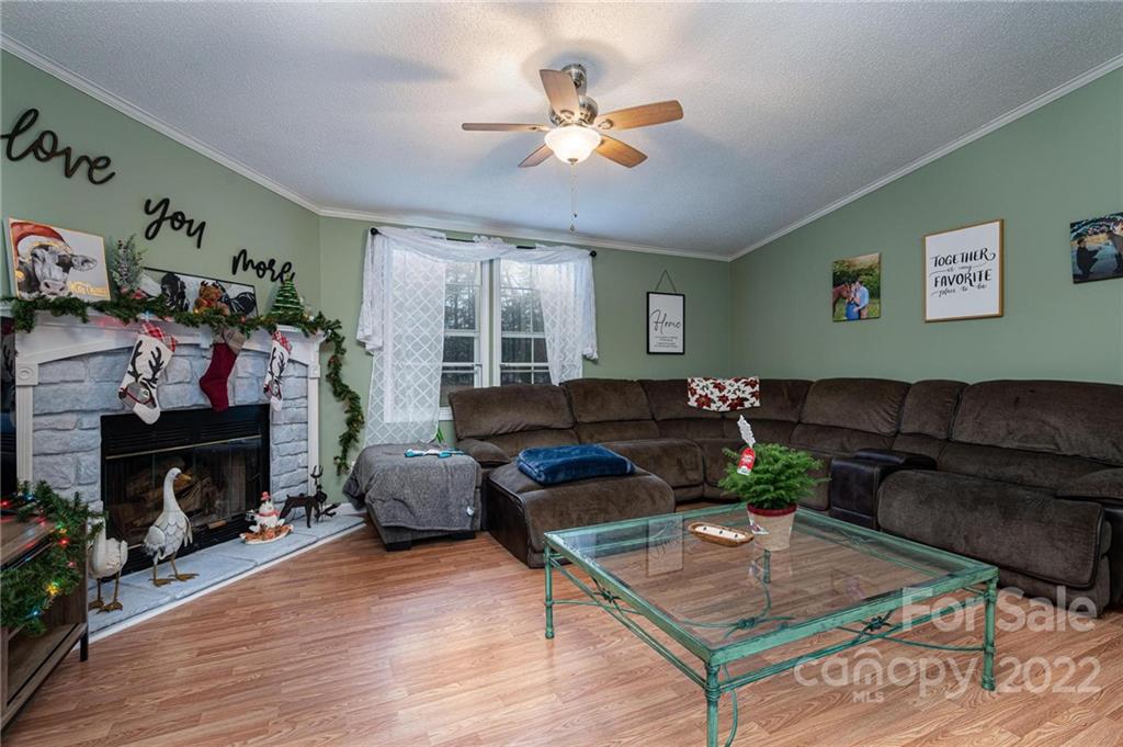 2776 Devine Road Iron Station, NC 28080 - Photo 5 of 23 a living room with furniture and a fireplace