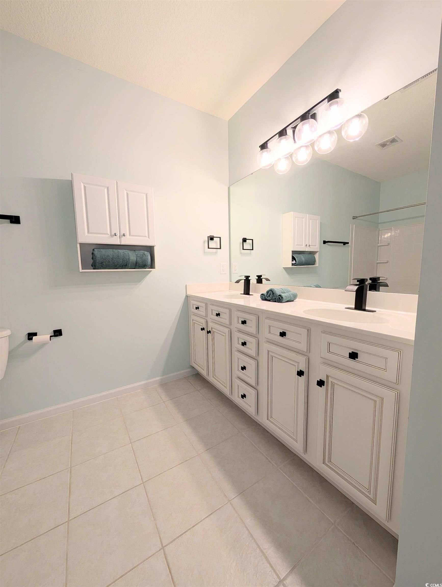 822 Sail Lane Murrells Inlet, SC 29576 - Photo 17 of 34 Bathroom with double vanity and light tile patterned flooring