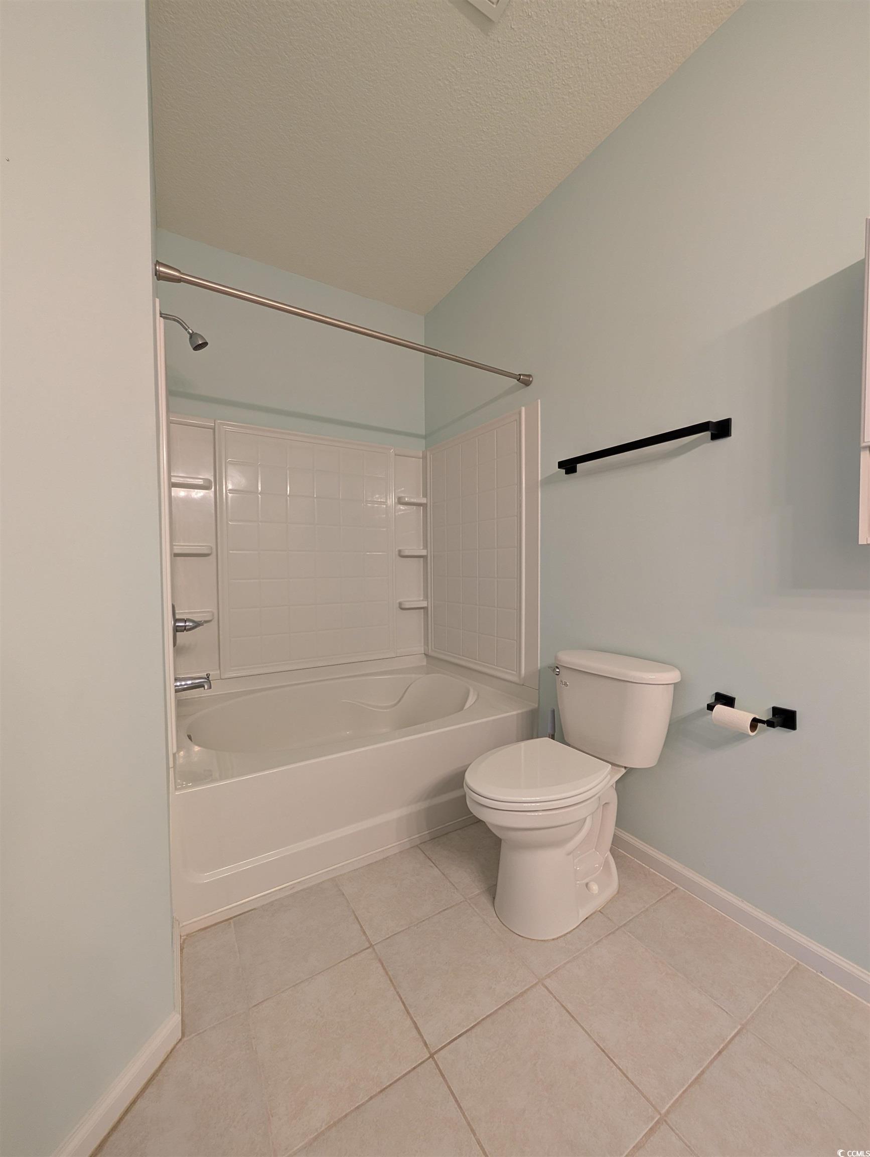 822 Sail Lane Murrells Inlet, SC 29576 - Photo 18 of 34 Bathroom featuring shower / bathtub combination, light tile patterned floors, and a textured ceiling