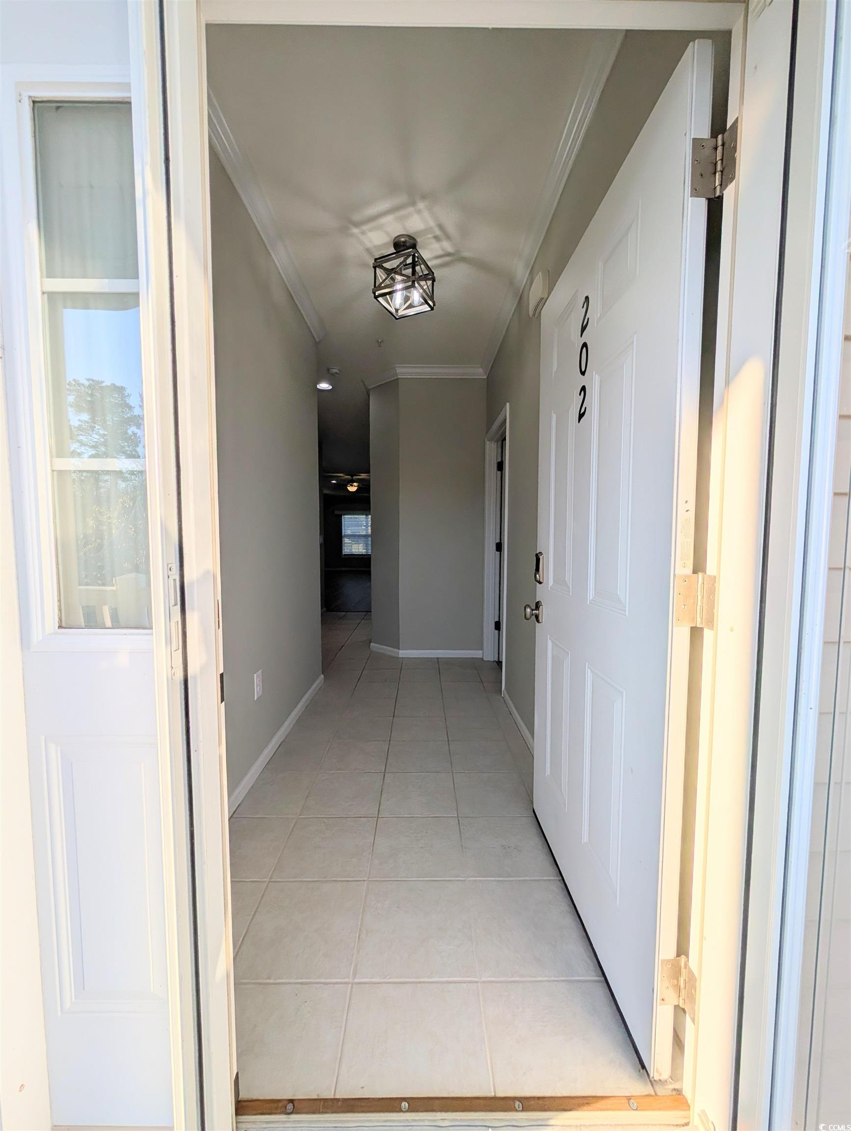 822 Sail Lane Murrells Inlet, SC 29576 - Photo 4 of 34 Hall featuring light tile patterned flooring and crown molding
