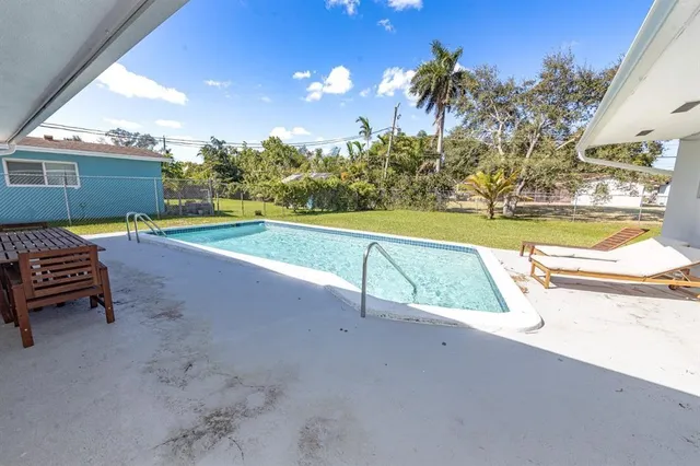 a view of a swimming pool with a lounge chairs