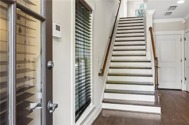 a view of staircase with white walls and windows