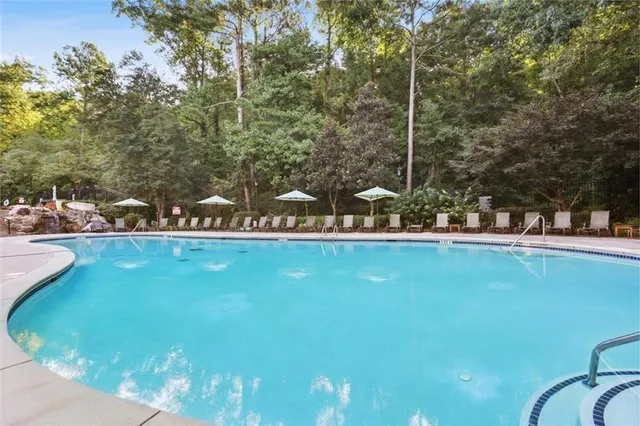 a kitchen with stainless steel appliances granite countertop a sink a stove and cabinets