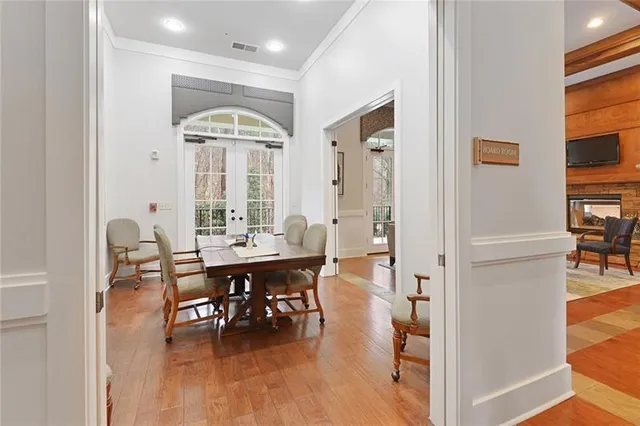 a view of a patio with table and chairs and a barbeque