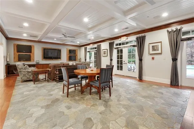 a view of a patio with table and chairs and potted plants with wooden floor and fence