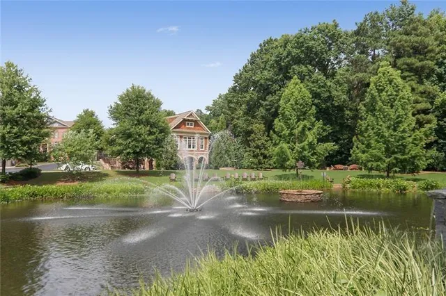 a view of yard with swimming pool and green space