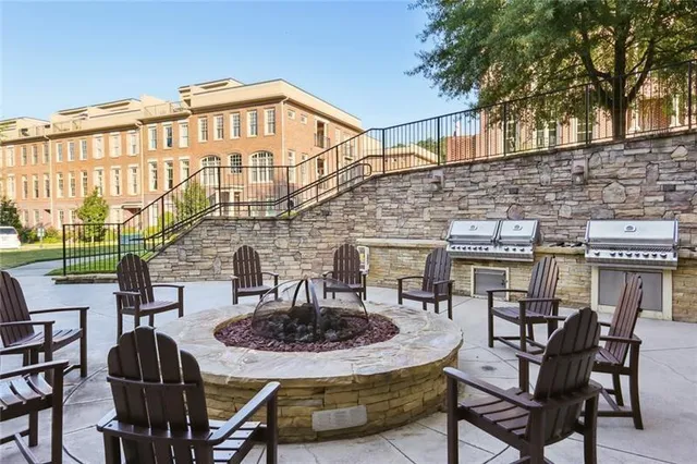 a front view of a house with garden and trees