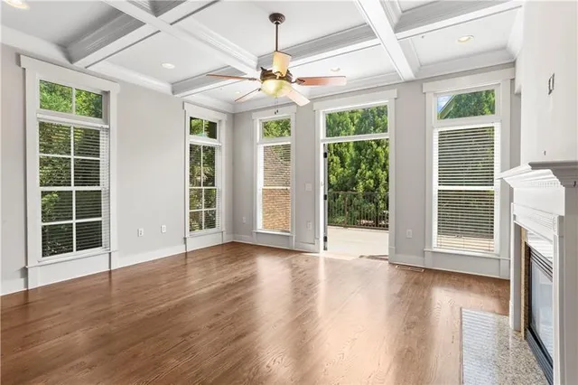 a kitchen with kitchen island granite countertop wooden cabinets a refrigerator a sink and wooden floors