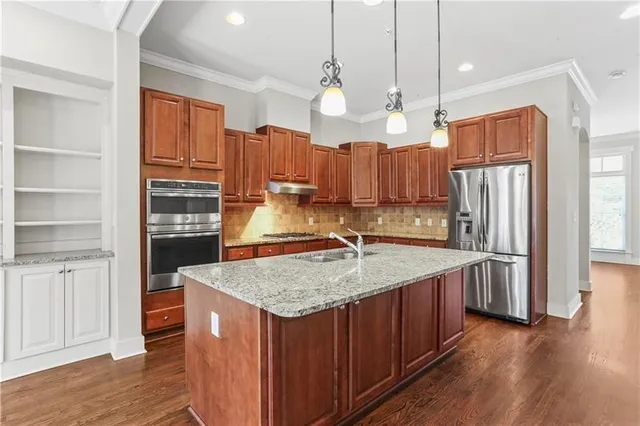 a kitchen with wooden cabinets and a stove top oven