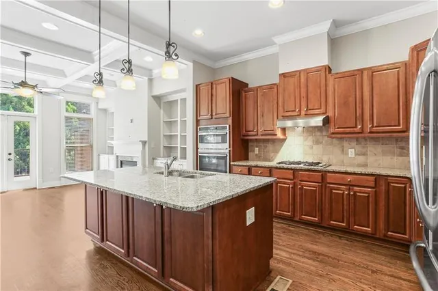 a open kitchen with granite countertop a sink and a refrigerator