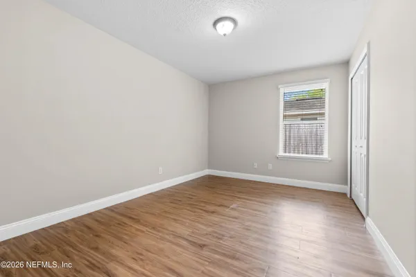 wooden floor in an empty room with a window