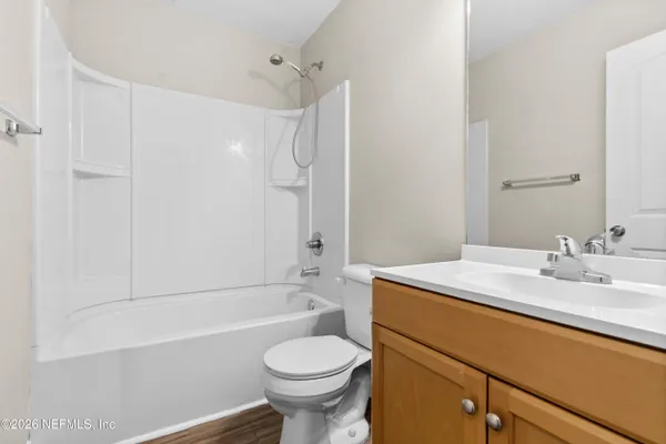 a bathroom with a sink toilet vanity and shower