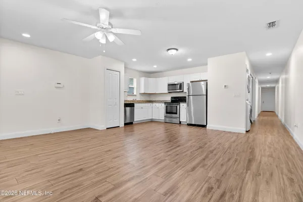 a view of kitchen with wooden floor and window