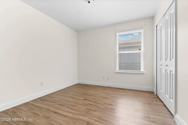a view of a room with wooden floor and windows