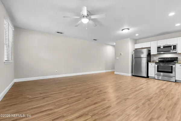a view of kitchen with granite countertop cabinets and steel appliances